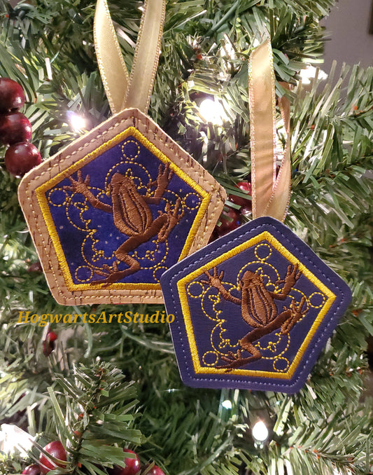 two purple frog ornaments on a tree