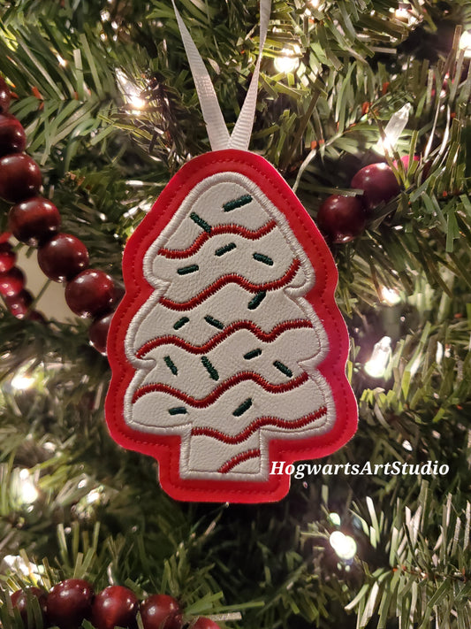 white and red snack cake ornament on tree