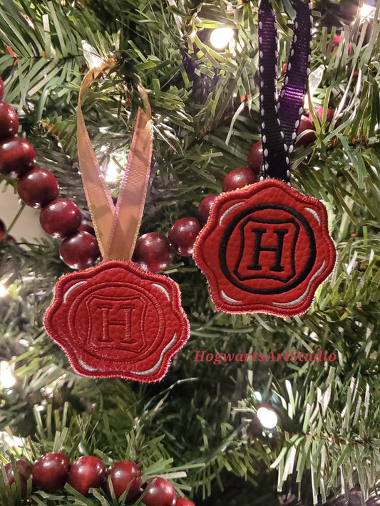 two wax seal ornaments on a tree