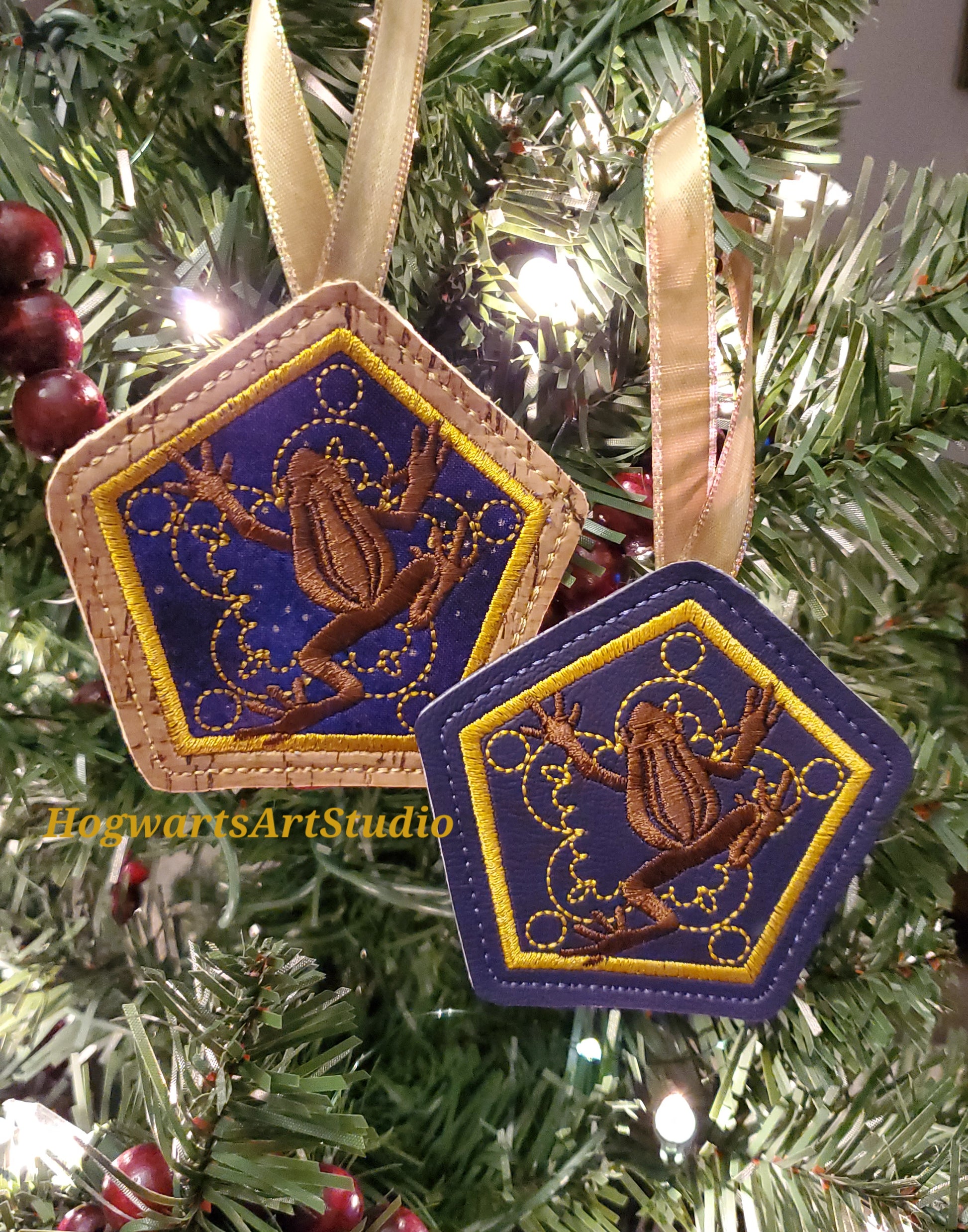 two purple frog ornaments on a tree